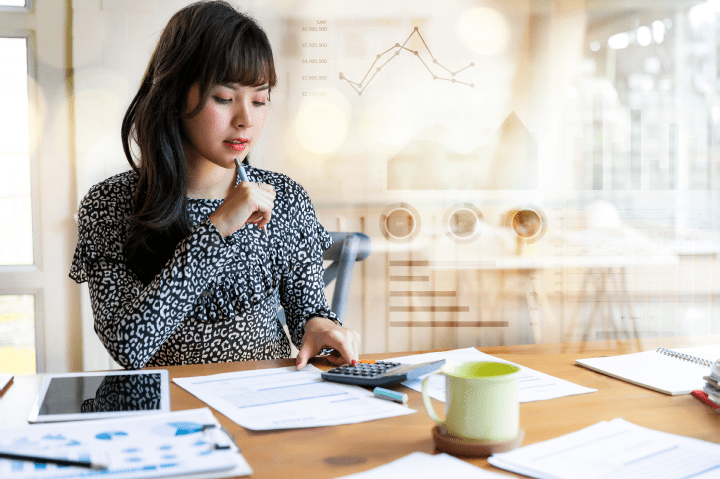 Happy beautiful asian woman working about financial with business report and calculator.financial or accounting concept.