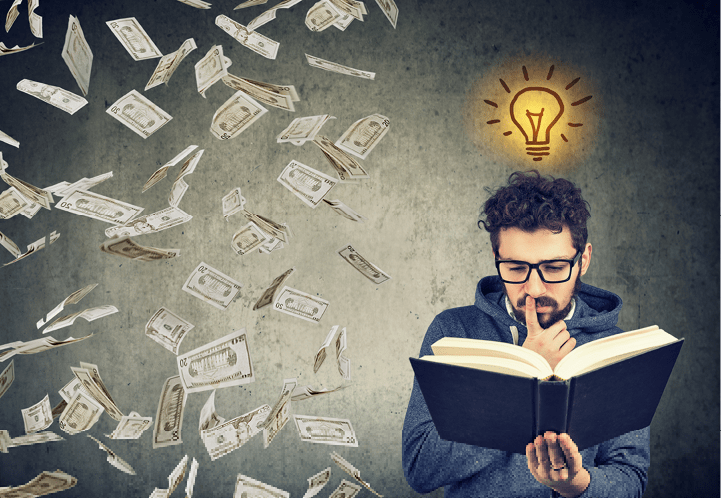 Man student reading a book has a bright idea how to earn money 